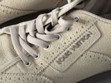 someone is wearing a pair of white sneakers with white laces on them