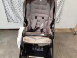 a stroller with a baby seat in the middle of it