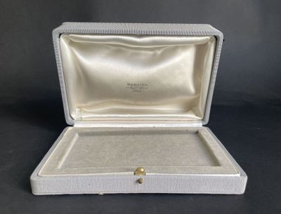 an open box with a ring inside of it on a black surface