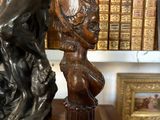 a bronze statue of a woman holding a shield