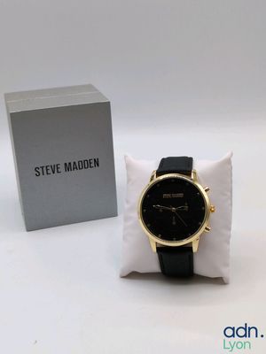 the watch is sitting on a pillow next to a box