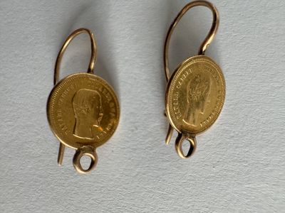 pair of gold toned earrings with a coin hanging from them