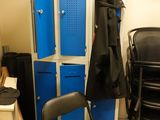 an image of a room with blue lockers and a chair