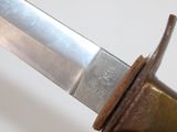 a close up of a knife on a white surface