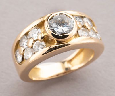 a close up of a gold ring with a white diamond