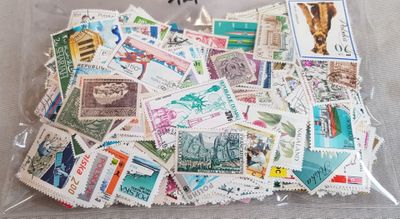 a bag full of postage stamps sitting on a table