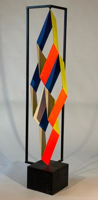 a sculpture made out of colored paper on a black stand