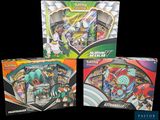 a close up of three boxes of pokemon cards on a black background