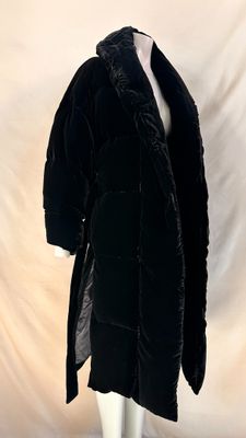 black velvet coat with fur collar and cuffs on a mannequin mannequin mannequin mannequin mannequin mannequin mannequin mann