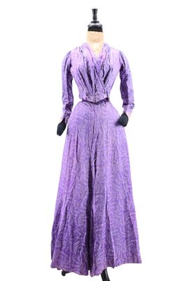 purple dress on a mannequin stand with gloves and gloves