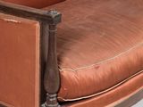 an image of a brown leather chair with a wooden frame