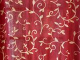 a red curtain with a white floral design on it