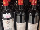many bottles of wine sitting on a shelf in a store
