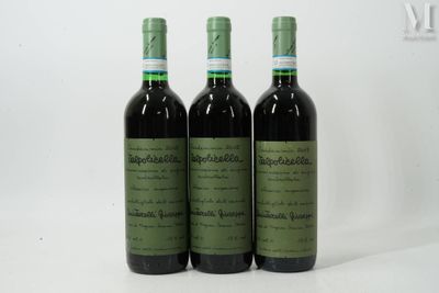 three bottles of wine sitting next to each other on a white surface