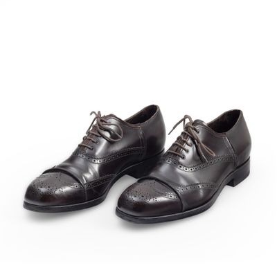 brown leather shoes with laces on a white background