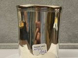 a silver cup with a sticker on it sitting on a counter