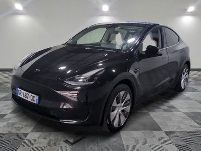 an image of a black electric car parked in a garage
