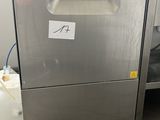 a silver dishwasher sitting on the floor in a kitchen