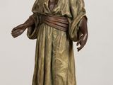 bronze statue of a woman with a turban on her head