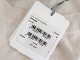 a label on a t - shirt that is attached to a hanger