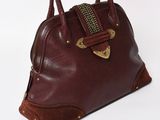 brown leather handbag with gold hardware on top of white background