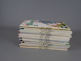 several children ' s books stacked on top of each other on a table