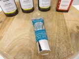 five different types of toothpaste sitting on a wooden table