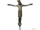 an image of a bronze statue of a person on a cross