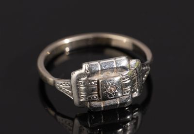 an image of a diamond ring on a black surface
