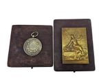 an old book with a coin on it and a keychain
