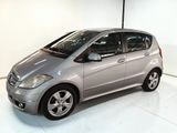 the silver car is parked in a white room with a white floor