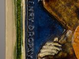 a tile with a picture of a man holding a baseball bat