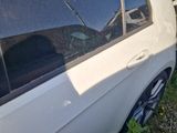 a white car that is parked on the side of the road