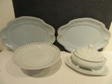 two plates and a bowl sitting on a table
