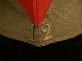 a close up of a hat with a red heart on it
