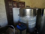 a large metal tank sitting next to a blue can