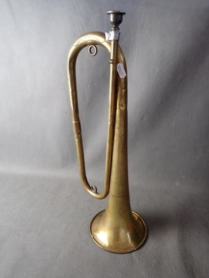 an old brass trumpet sitting on top of a table