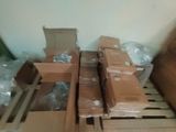 a pile of boxes sitting on a pallet in a room