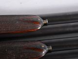 a close up of a pair of black and red baseball bats