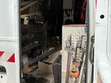 a white van with a red stripe parked in a garage