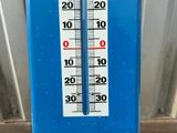 a thermometer that is on the side of a building