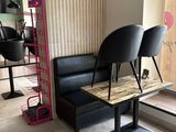 two black chairs and a table in a room