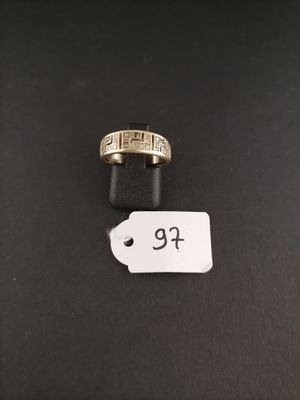 a gold ring with a price tag on top of it