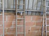 two ladders that are leaning against a wall