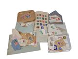 many different types of stamps and envelopes laid out on the floor