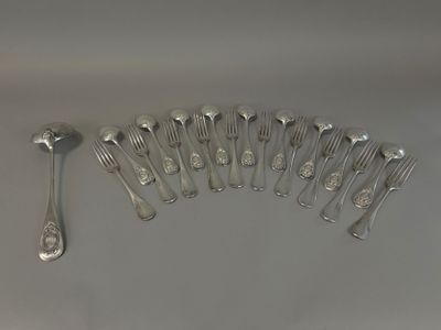 many forks and spoons laid out on the table