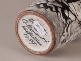 a black and white vase with writing on it