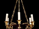 a brass and red glass chandelier hanging from a chain