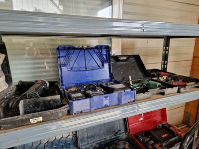 many tools on a shelf in a garage