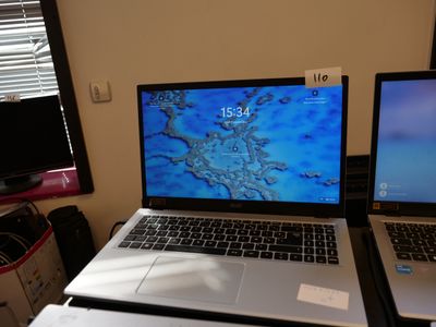 two laptops sitting side by side on a desk